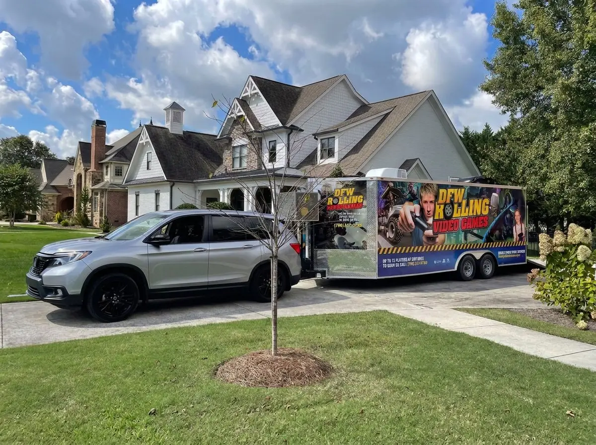 The DFW Rolling Video Games trailer towed into a driveway for a birthday party